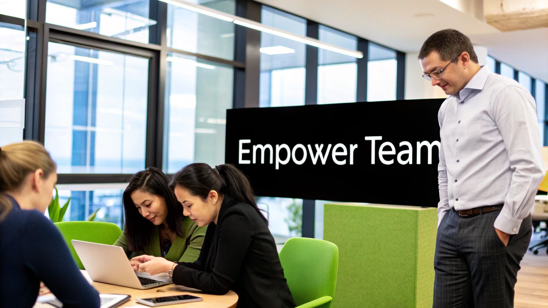 A manager and team member having a positive, supportive conversation in a relaxed office environment.