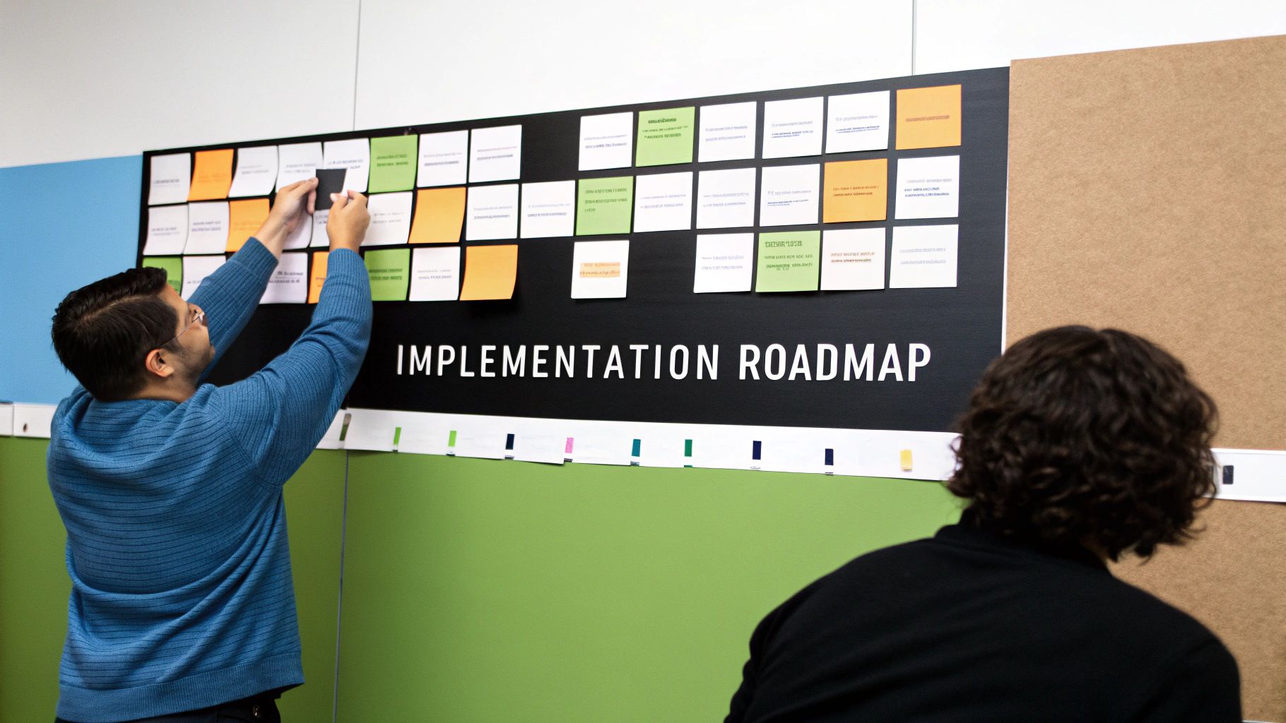 A person at a desk drawing out a plan on paper, representing a strategic roadmap.