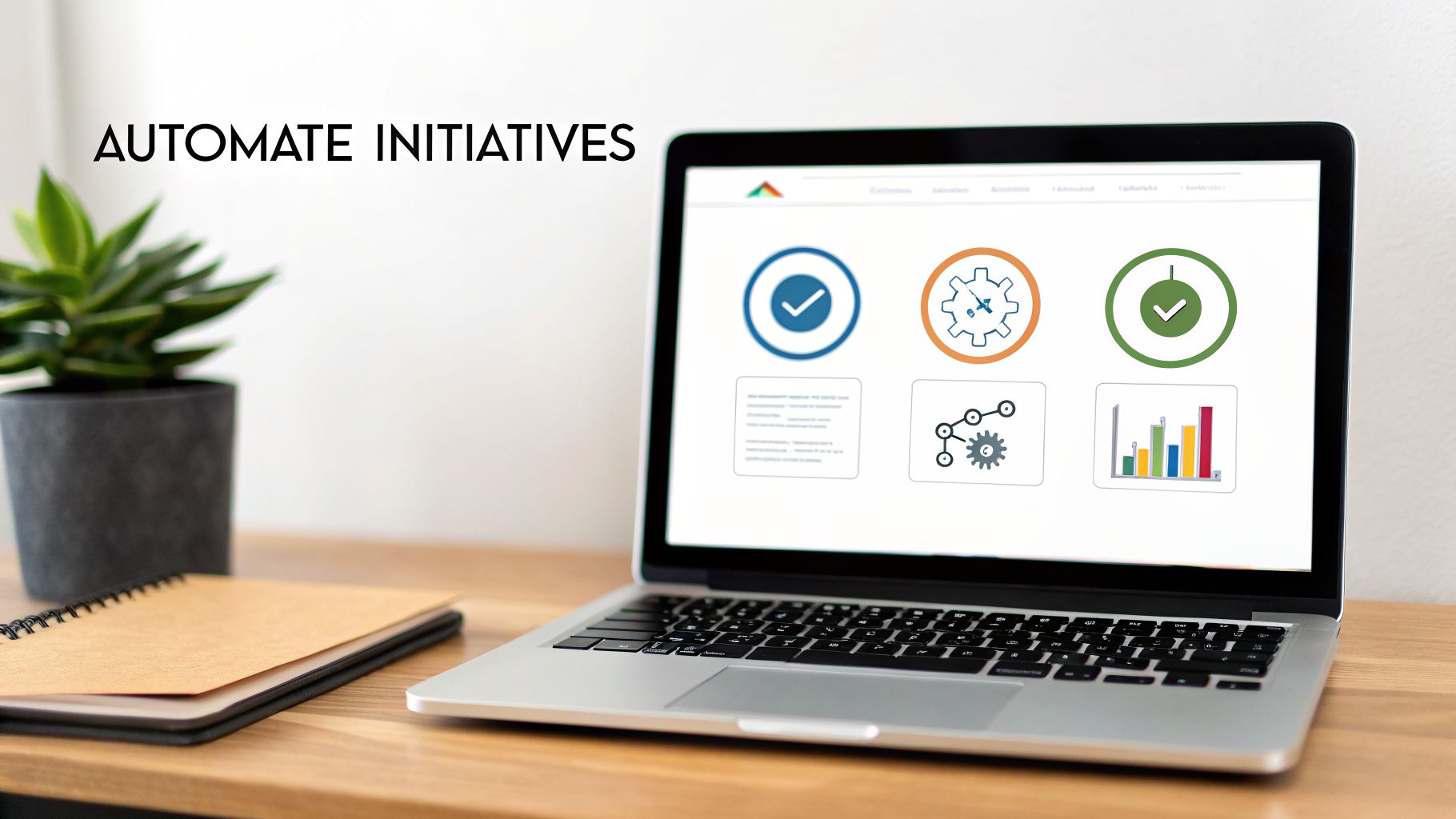 A laptop on a wooden desk displaying software icons for automating initiatives, next to a plant and notebook.