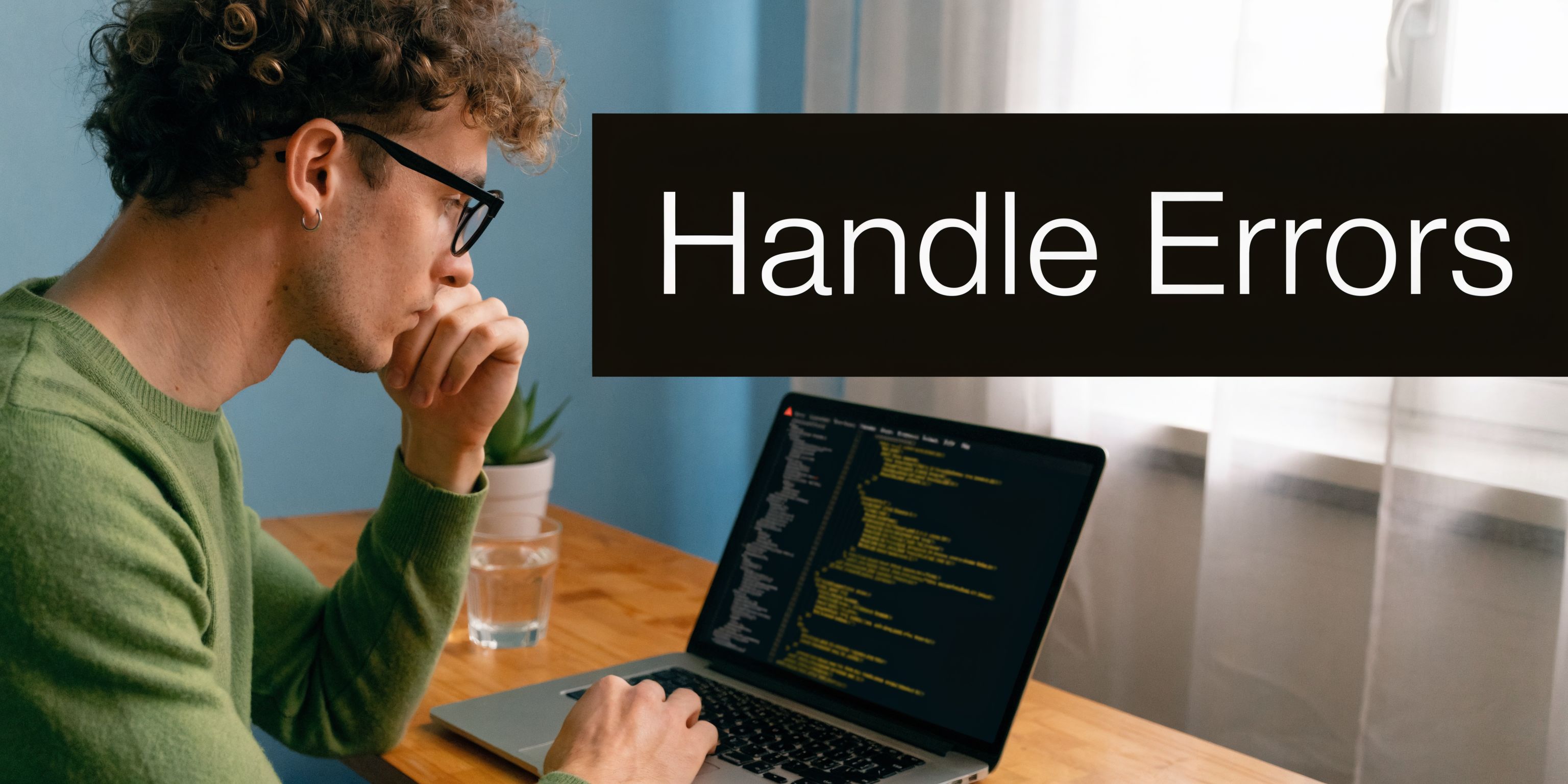 A curly-haired man wearing glasses looking thoughtfully at code displayed on his laptop screen while sitting.