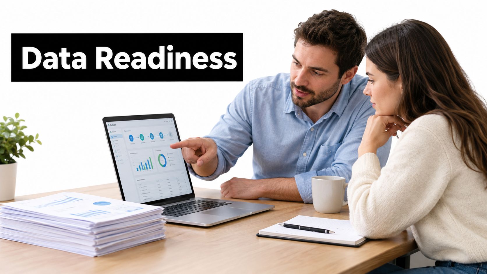 A professional man and woman discussing data analytics on a laptop screen in a modern office.